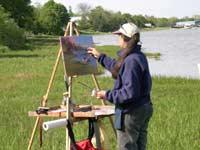 Rosalie Nadeau painting an oil painting en plein air, with her Take It Easel. Rosalie Nadeau says the Take It Easel is the best plain air easel.